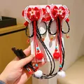 Red velvet Chinese New Year hair bow clip with long black braids and plush pom-poms - Peach Blossom Long Braid