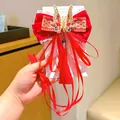 Red velvet New Year hair bow for girls with golden butterfly embroidery and tassels - Festive Butterfly