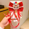 Red velvet bow hair clip with Chinese lion dance embroidery and golden tassels - Auspicious Lion