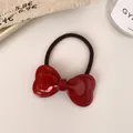 Elastic hair tie with a deep red bow ornament made of polished resin and black nylon - Red