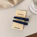 Set of two minimalist blue marble texture hair clips on a premium display card - Navy Blue