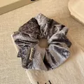 Elegant silver grey velvet scrunchie with metallic sheen and woven brand label - Blue