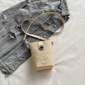 Chic cream woven bucket bag with elegant metal turn-lock closure and slim strap - Beige