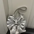 Silver metallic shoulder tote bag featuring a large bow design and long strap - Silver