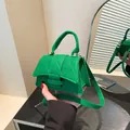 Mini emerald green crossbody bag with quilted pattern and gold hardware accents - Green
