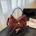 Deep wine red velvet tote bag featuring a large bow and golden heart pendant charm - Brown