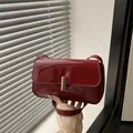 Minimalist glossy dark red patent leather crossbody bag with golden metal clasp - Red