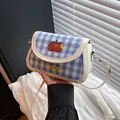 Blue and white checkered crossbody saddle bag with apple motif and leather trim - White