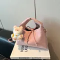 Pink minimalist crossbody dumpling bag with a cute plush charm and drawstring closure - Pink With Pendant