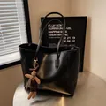 Retro black leather tote bag with plush bunny charm on a modern minimalist table - No Pendant / Black