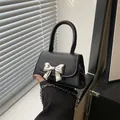 Elegant black mini handbag with silver metal bow buckle and chain strap - Black