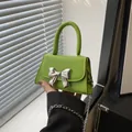 Neon green mini crossbody bag with silver bow accent and metal chain strap - Green