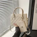 Chic off-white quilted diamond pattern handbag with matching mini pouch and metal handles - White