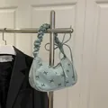 Light blue-green corduroy underarm bag with black bow print and ruched handle detail - Green