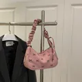 Pink corduroy underarm bag with black bow print and ruched handle for a sweet casual look - Pink
