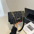 Classic black quilted crossbody bag with golden chain strap and rectangular metal clasp - Black