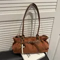 Retro warm brown suede tote bag featuring a leather strap and ethnic beaded charm detail - Brown