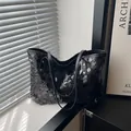 Chic black sequin tote bag with sleek shoulder straps and polished metal rivets - Black