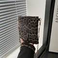 Chic leopard print crossbody bag with gold chain strap in a stylish rectangular design - Brown