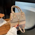 Chic beige shoulder bag with glitter texture and gold V-shaped logo and tassels - Gold