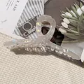 Iridescent large transparent acrylic hair claw clip with golden spring on woven background - Cross Twisted Large Claw / Off White