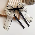 Polka dot tulle bow hair clip with black ribbon accent on velvet jewelry tray - Mesh Bow Tie Style