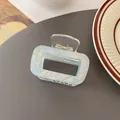 Iridescent light blue rectangular hair claw clip with golden spring on dark surface - Rectangular Hollow Claw / Iridescent Sky Blue