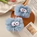 Set of two light blue plush wristbands featuring cute 3D cartoon monster eyes design - Blue Plush Style