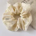 Elegant cream lace hair scrunchie with floral embroidery and branded fabric label - Scrunchie Style / Off White