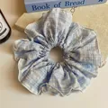 Large light blue and white plaid scrunchie with a soft ruffled fabric design - Grid Style