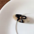 Vintage tortoiseshell acetate hair clip with black bow and sparkling champagne rhinestone - Light Tortoiseshell Oval Clip
