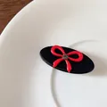 Retro black acetate hair clip with a red 3D bow and sparkling rhinestone accent - Black Oval Hair Clip
