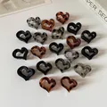 Variety of heart-shaped leopard print hair claws in acetate resin and marble finishes - Heart Style