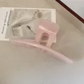 Minimalist light pink hair claw clip with pearlescent finish for stylish hair styling - Pink
