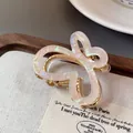 Mini butterfly claw clip with iridescent white wings and gold-tone metal base - Gradient White