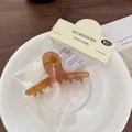 Amber acetate hair claw clip with vintage handmade packaging in a minimalist style - Caramel Cross Claw