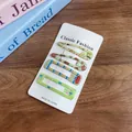 Set of four light green candy-colored hair clips with cute bear patterns on card - Colorful Green
