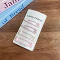 Set of 4 pastel plaid and striped fabric hair clips on a classic display card - Pink Grid