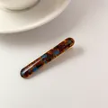 Acetate hair barrette featuring blue tortoise shell pattern and golden artistic lettering - Blue-Brown