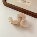Elegante pinza para el pelo ondulada nacarada en rosa crema con dientes de metal dorado - Pinza Nacarada