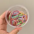Elastici per capelli color macaron con motivi floreali in un cilindro trasparente - Motivo Floreale / Grande / Colorato