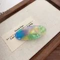 Vintage oval acetate hair clip with colorful marble texture and gold lettering - Colorful Floral Oval