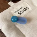 Handmade hair clip featuring deep teal beads and lavender resin with gold lettering - Blue