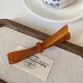 Elegant amber acetate resin bow hair clip with polished finish for a classic look - Coffee Spring Clip
