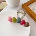 Translucent grey hair claw clip featuring five colorful 3D resin hearts on white ceramic - Colorful Hearts Style