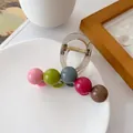 Colorful ball hair claw clip with pink and green spheres on a clear acrylic frame - Iridescent Ball Style