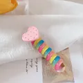 Rainbow gradient spiral hair tie with a pink heart charm on textured cotton fabric - Pink Heart