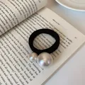 Black high-elasticity hair tie featuring two cream-colored pearls on a book - Double Pearls Style