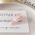 Pink and white striped geometric hair clip with translucent finish on aesthetic card - Teardrop