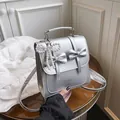 Silver metallic bow backpack with pearl charm and fashion lettering detail - With Pendant / Silver